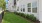 a building with a fence and grass lawn