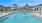 a large swimming pool with palm trees