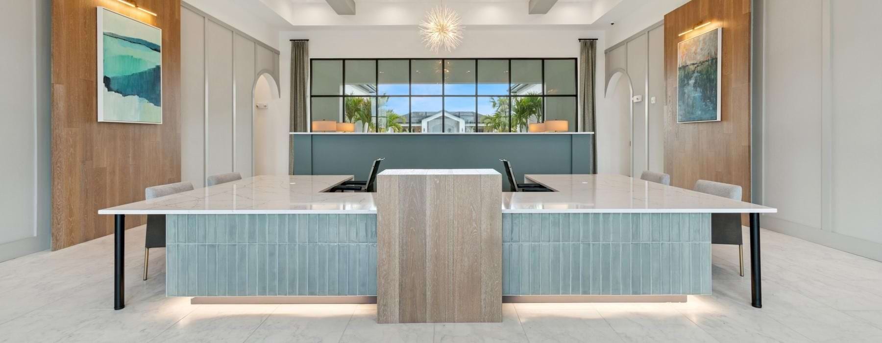 a large room with white countertop tabled and chairs