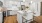 a kitchen with white cabinets a white island and a stovetop